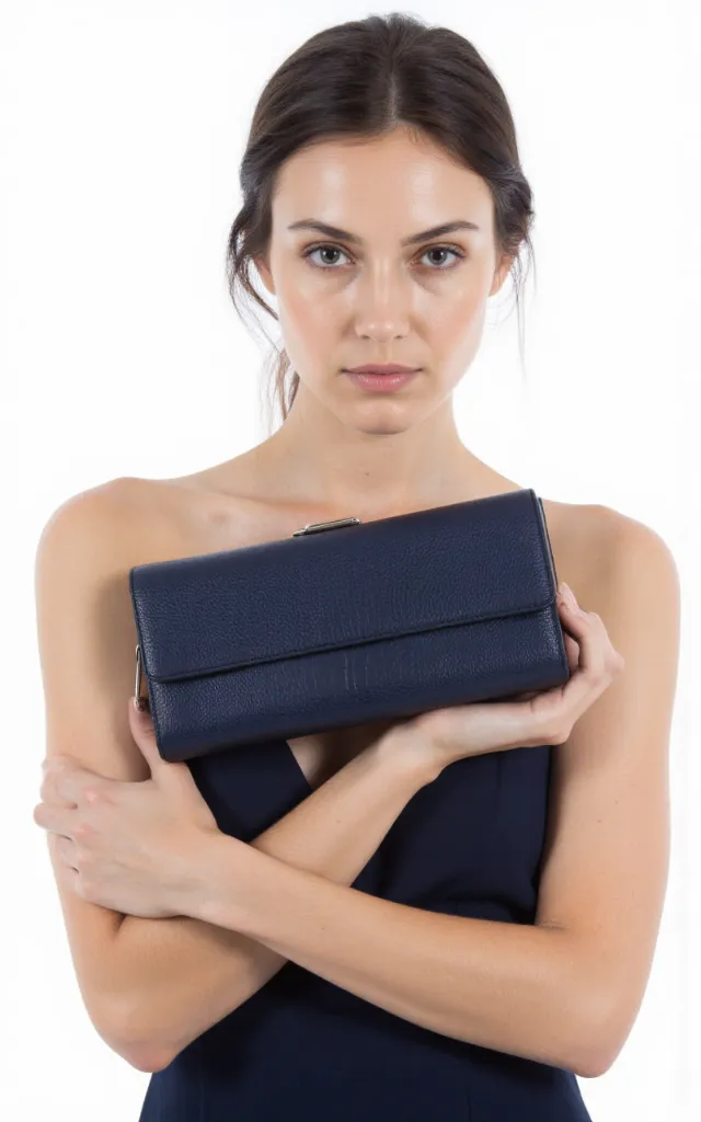 A French female model with a Clutch, wearing a dress, against a white background, in a front   facing close   up